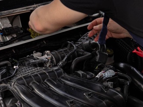 Mechanic working in a car engine bay
