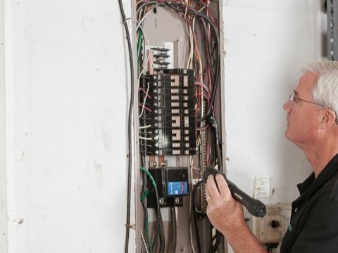 Electrician working on a breaker panel