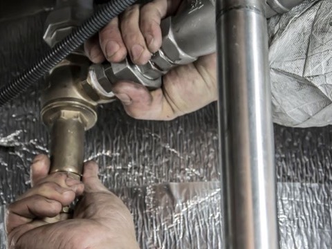 Plumber installing pipe fittings